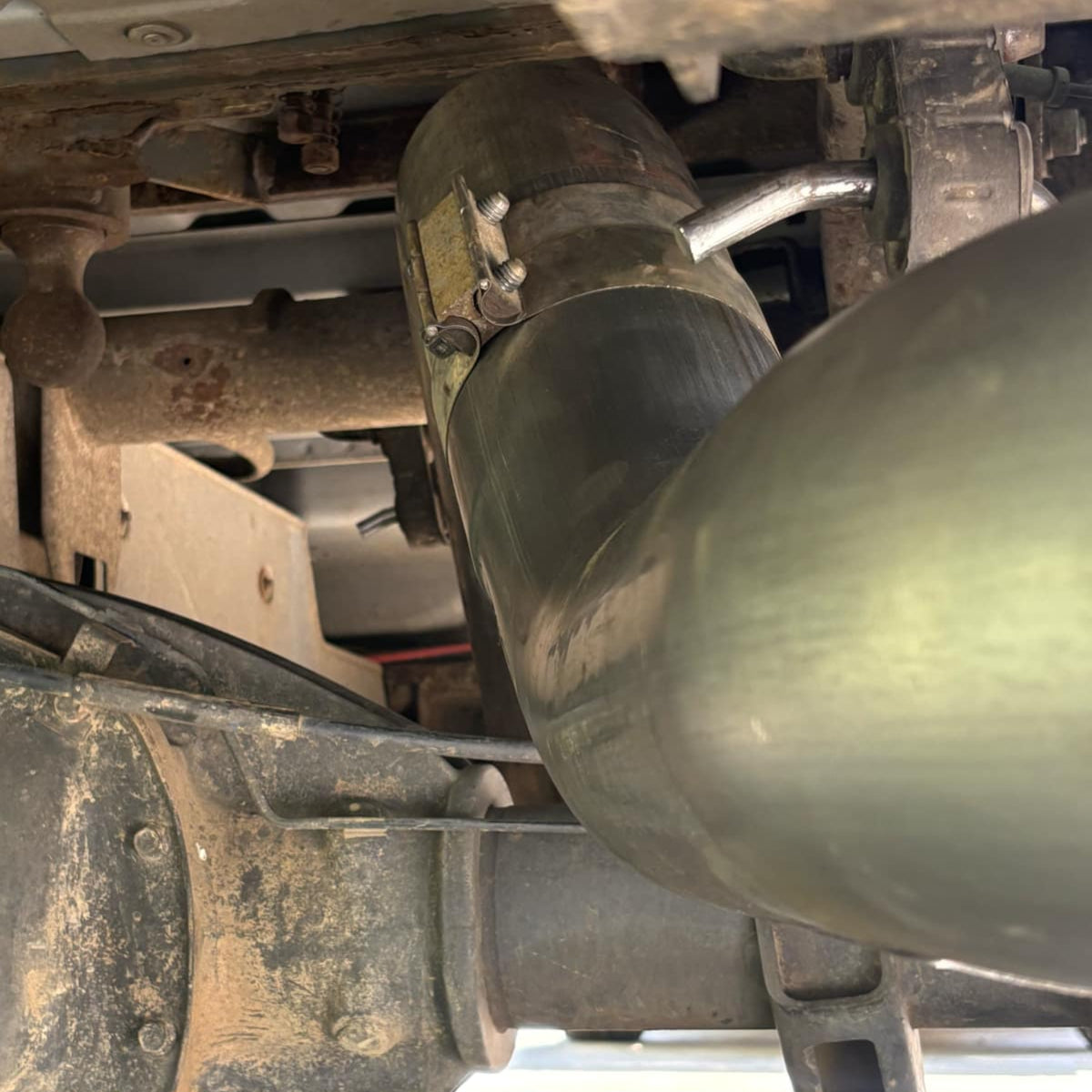 Pair of stainless steel 5-inch exhaust tailpipe sections for Duramax 2001-2027 by DP Customs, showing polished finish and mounting ends.
