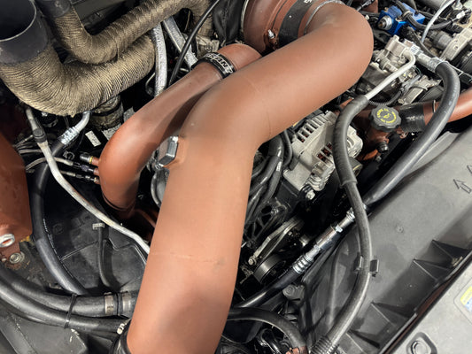 DP Customs 03-07 Duramax front route AC suction line shown in black rubber with metal fittings on ends.