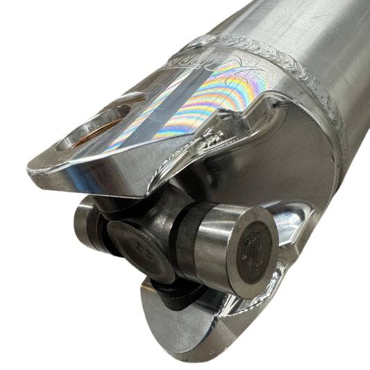 DP Customs 5-inch billet yoke driveshaft, close-up view showing sturdy metal construction and precision machining details.