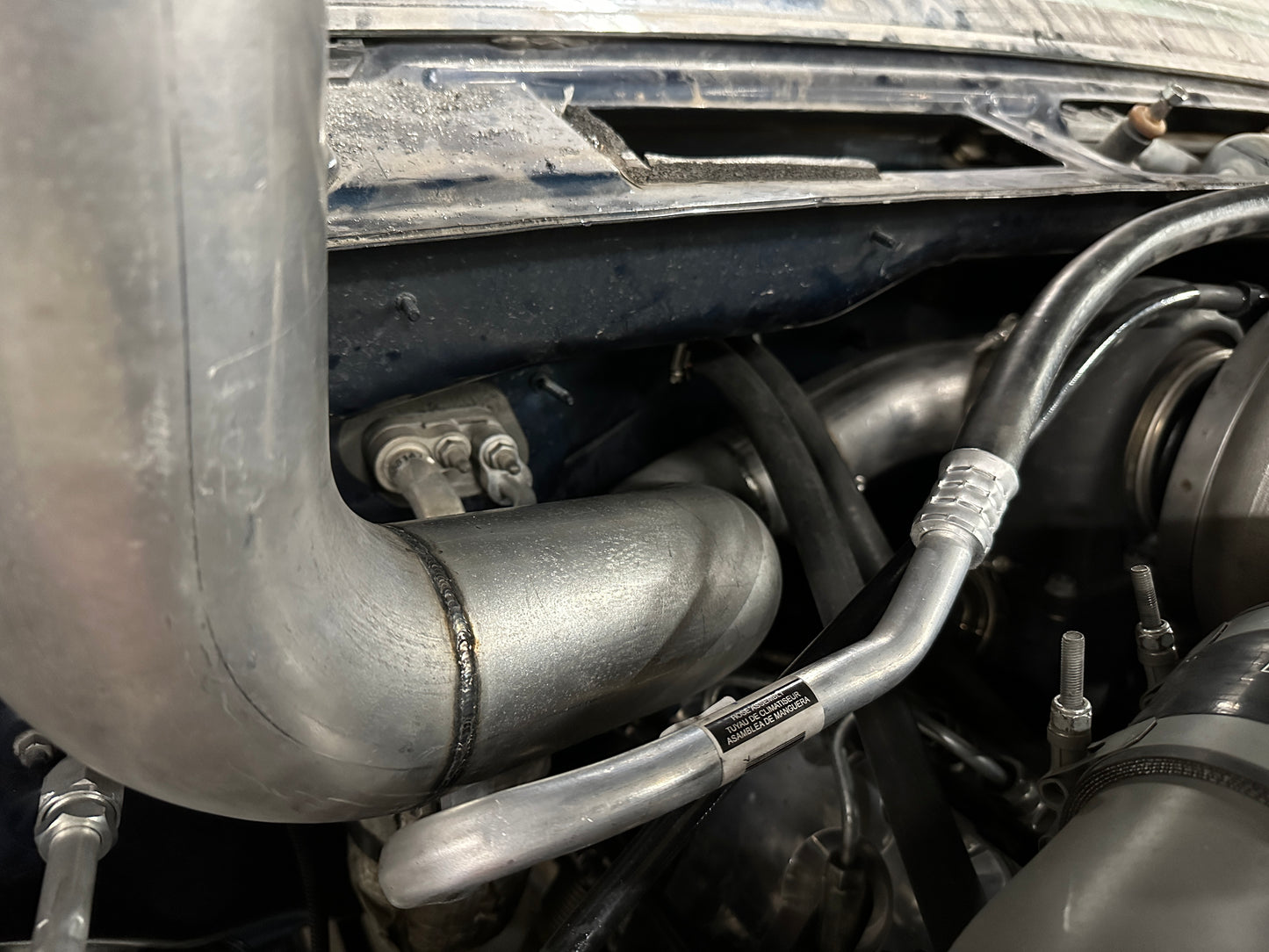 DP Customs Duramax S400 Hoodstack installed on a truck, showcasing the custom exhaust stack with polished metal finish.