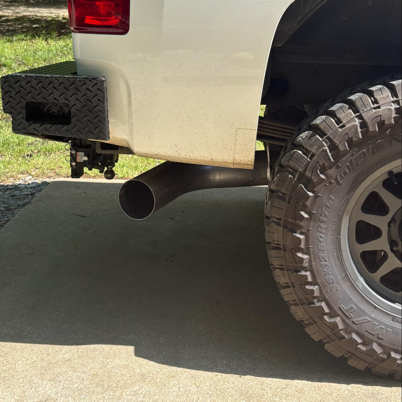 Duramax 2001-2027 stainless steel 5-inch exhaust tailpipe section by DP Customs, showing a polished, curved exhaust pipe.