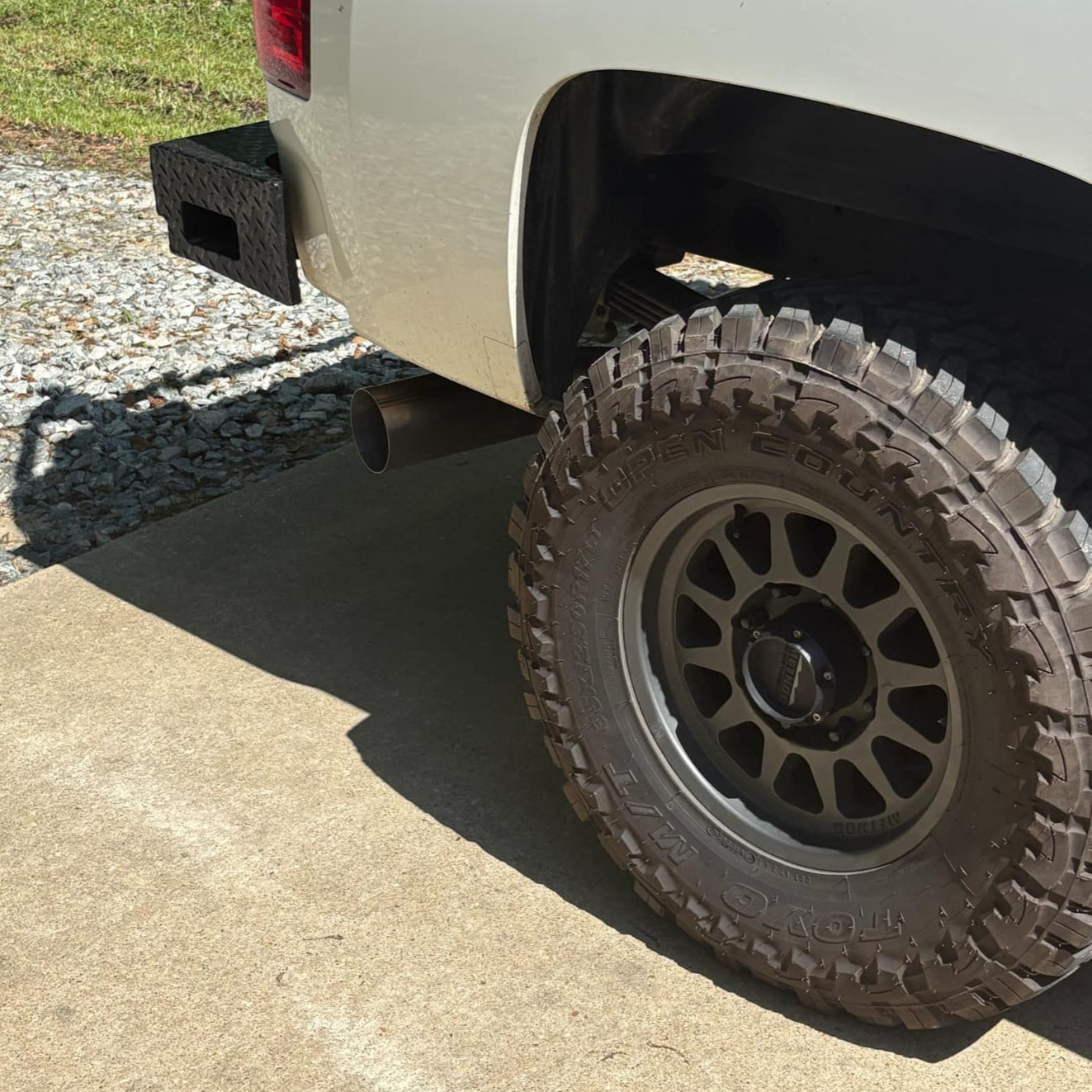 Duramax 2001-2027 stainless steel 5-inch exhaust tailpipe section by DP Customs, showing the polished, curved exhaust pipe component.