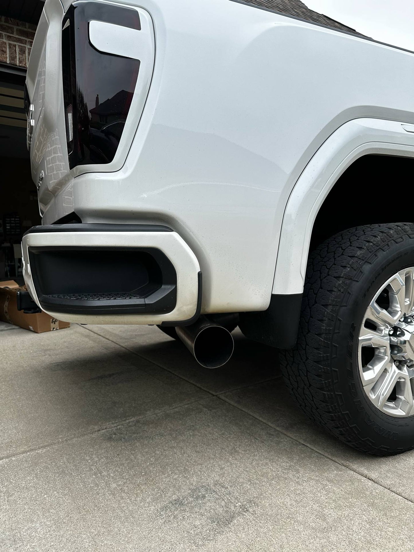 Duramax 2001-2027 stainless steel 5-inch exhaust tailpipe section by DP Customs, showing the polished metal pipe with smooth bends.