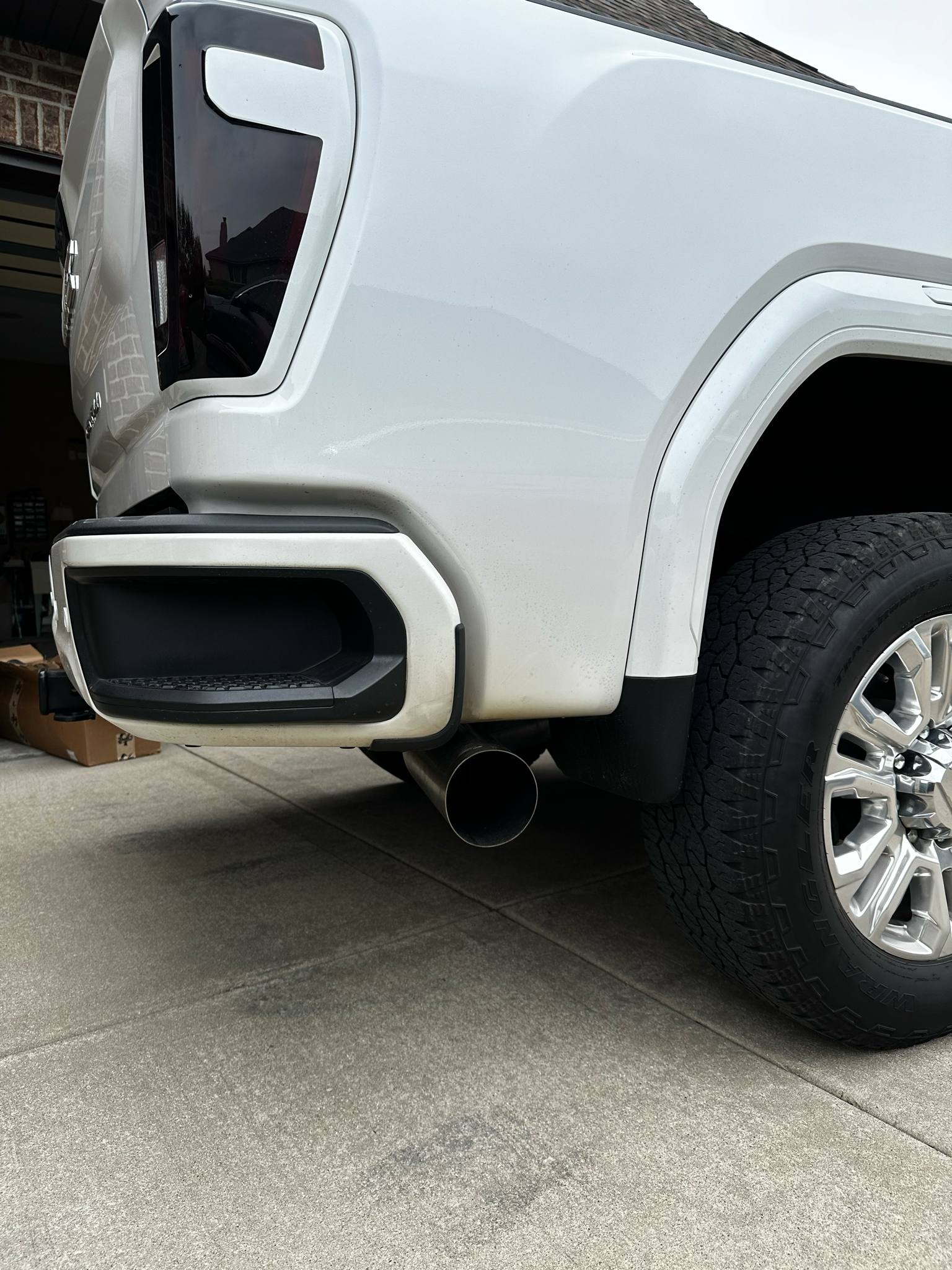 Duramax 2001-2027 stainless steel 5-inch exhaust tailpipe section by DP Customs, showing the polished metal pipe with smooth bends.