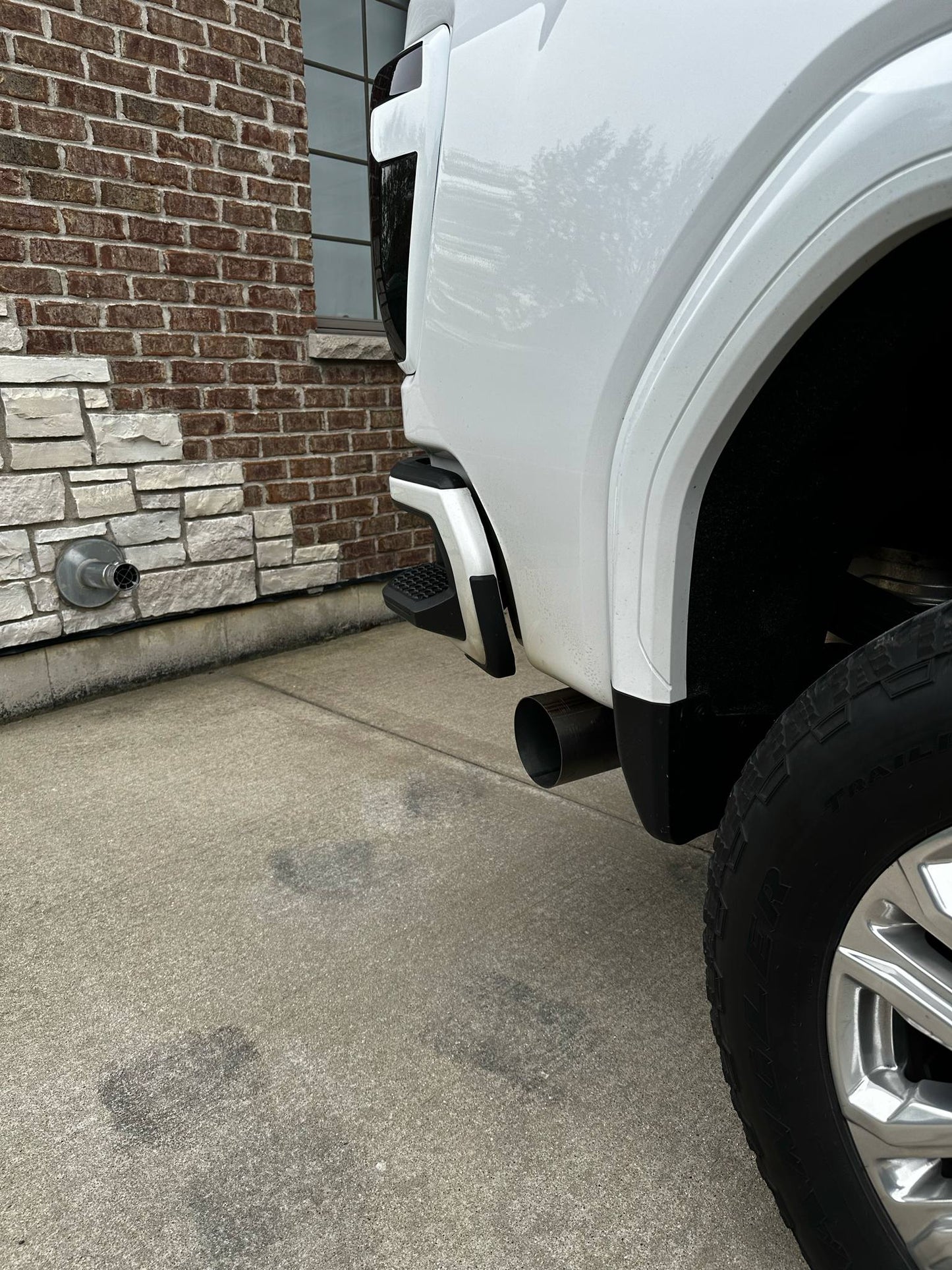 Duramax 2001-2027 5-inch stainless steel exhaust tailpipe section by DP Customs, showcasing the durable, polished pipe with smooth bends.