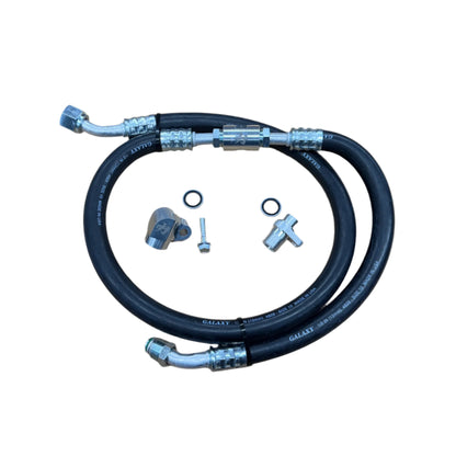 DP Customs 03-07 Duramax front route AC suction line showing metal tubing and fittings for vehicle air conditioning system.