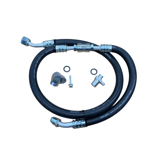 DP Customs 03-07 Duramax front route AC suction line showing metal tubing and fittings for vehicle air conditioning system.