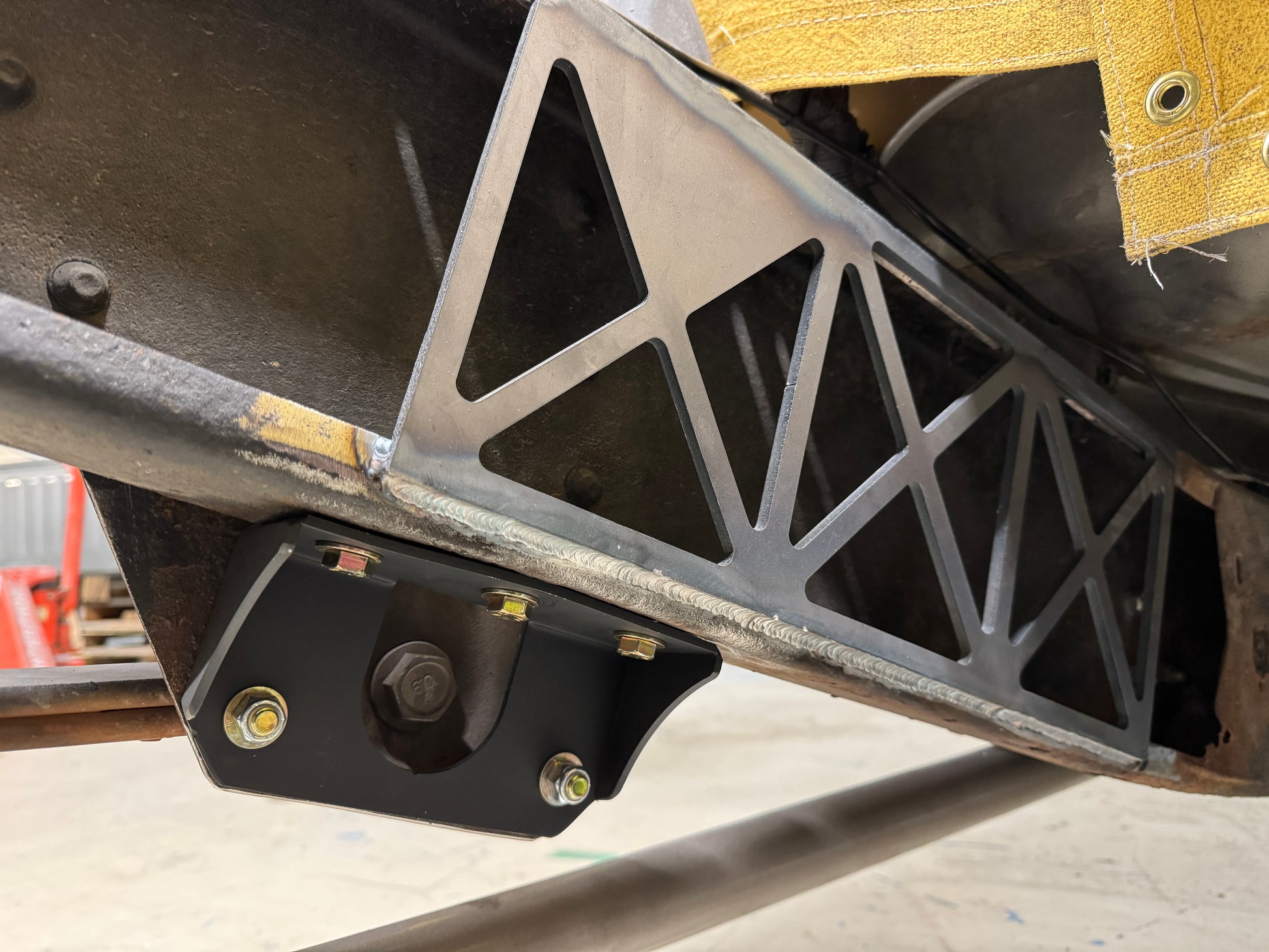 DP Customs GM HD frame support brace for 1999-2010 trucks, steel construction with mounting brackets visible in the image.