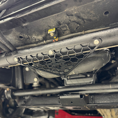 DP Customs Duramax radiator hose support bracket for 2001-2010 models, shown installed on engine for secure hose positioning.