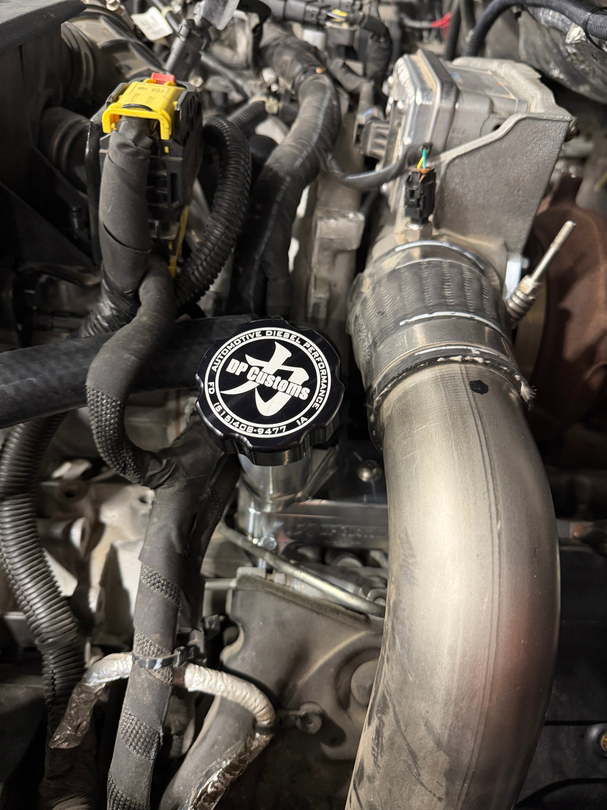 DP Customs 2017-2026 Duramax L5P billet CCV system showing polished metal components and hoses for diesel engine performance.