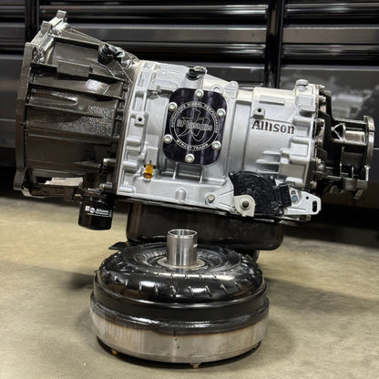 DP Customs Allison 750hp Street Transmission showing metal casing, gear components, and hydraulic linkages.