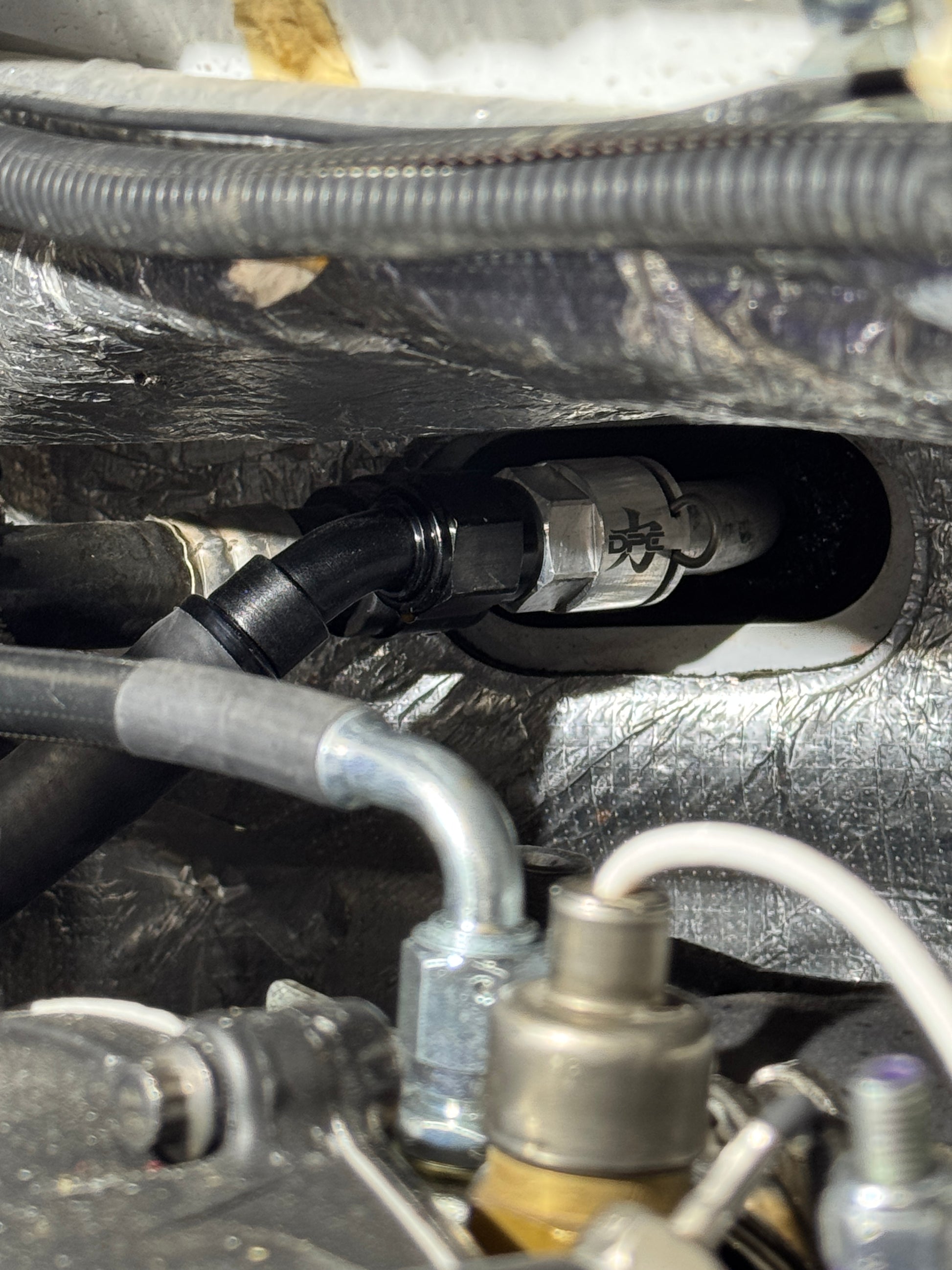 DP Customs billet -10 AN GM heater core adapter fitting shown, made of durable billet aluminum for automotive cooling system connection.