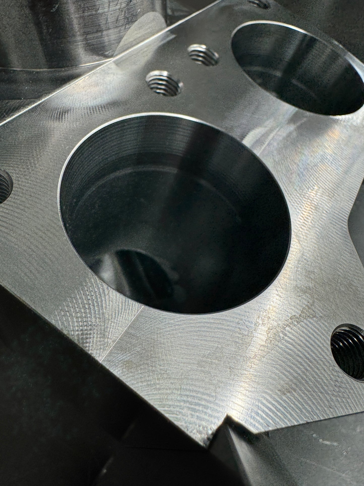 DP Customs Duramax billet T6 wastegate pedestal mounted on engine, showcasing precision-machined metal components.