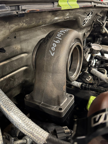 DP Customs Duramax billet T6 wastegate pedestal mounted on engine component with detailed machining and sturdy construction.