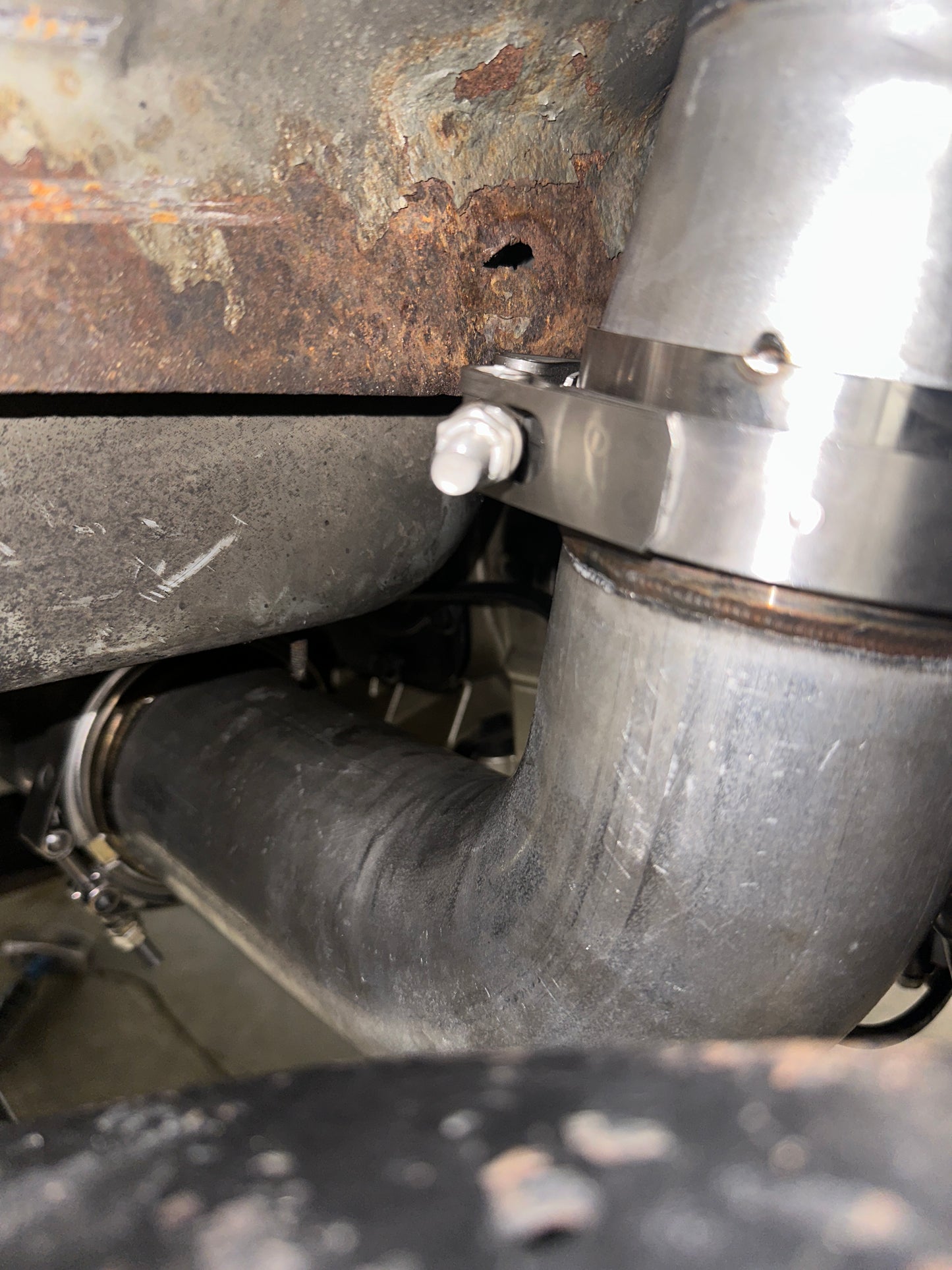 DP Customs Duramax S400 Downpipe showing polished stainless steel construction and precise fit for Duramax diesel trucks.
