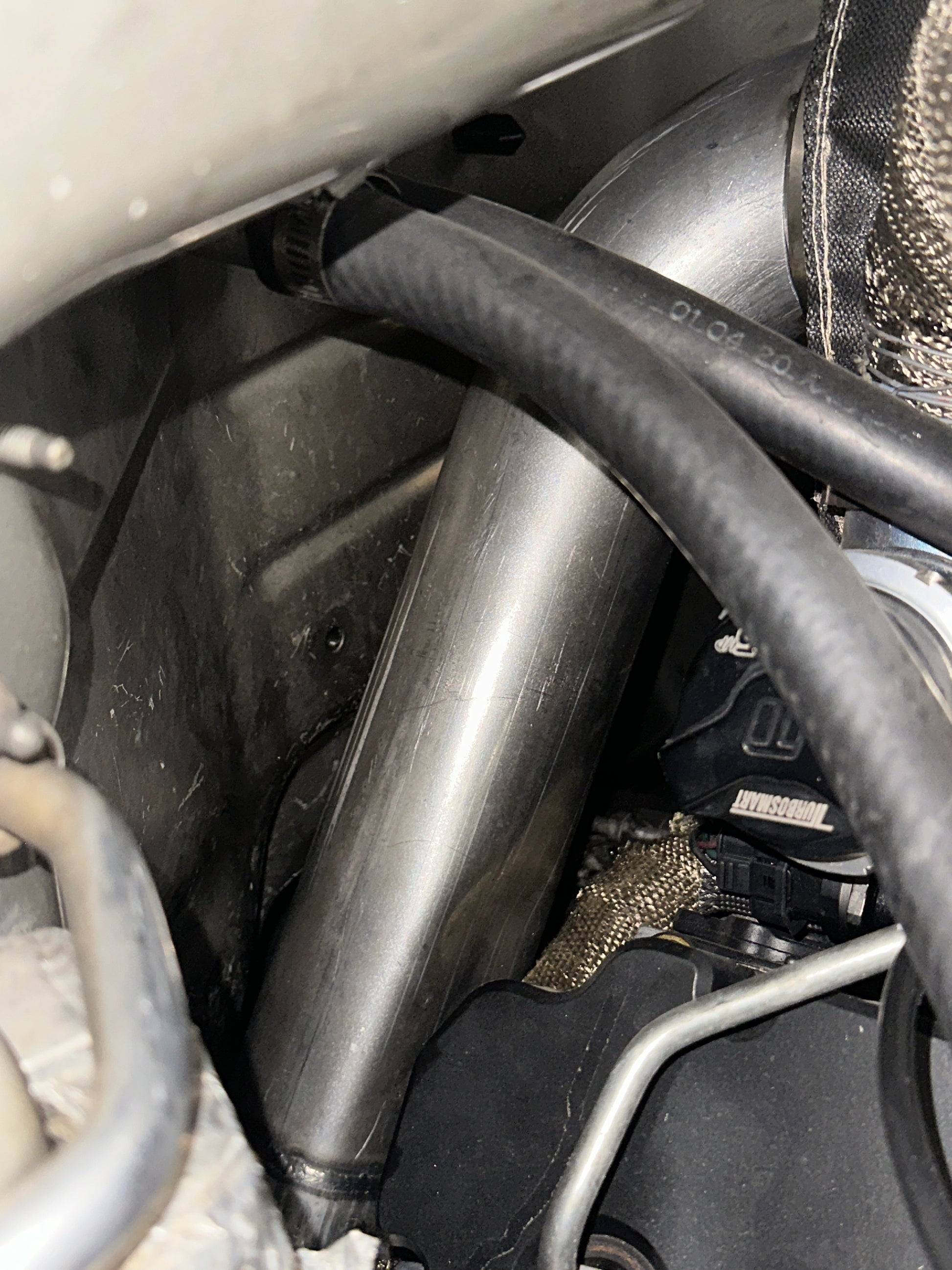 DP Customs Duramax S400 Downpipe showing polished stainless steel construction and flanged connections for diesel truck exhaust upgrade.
