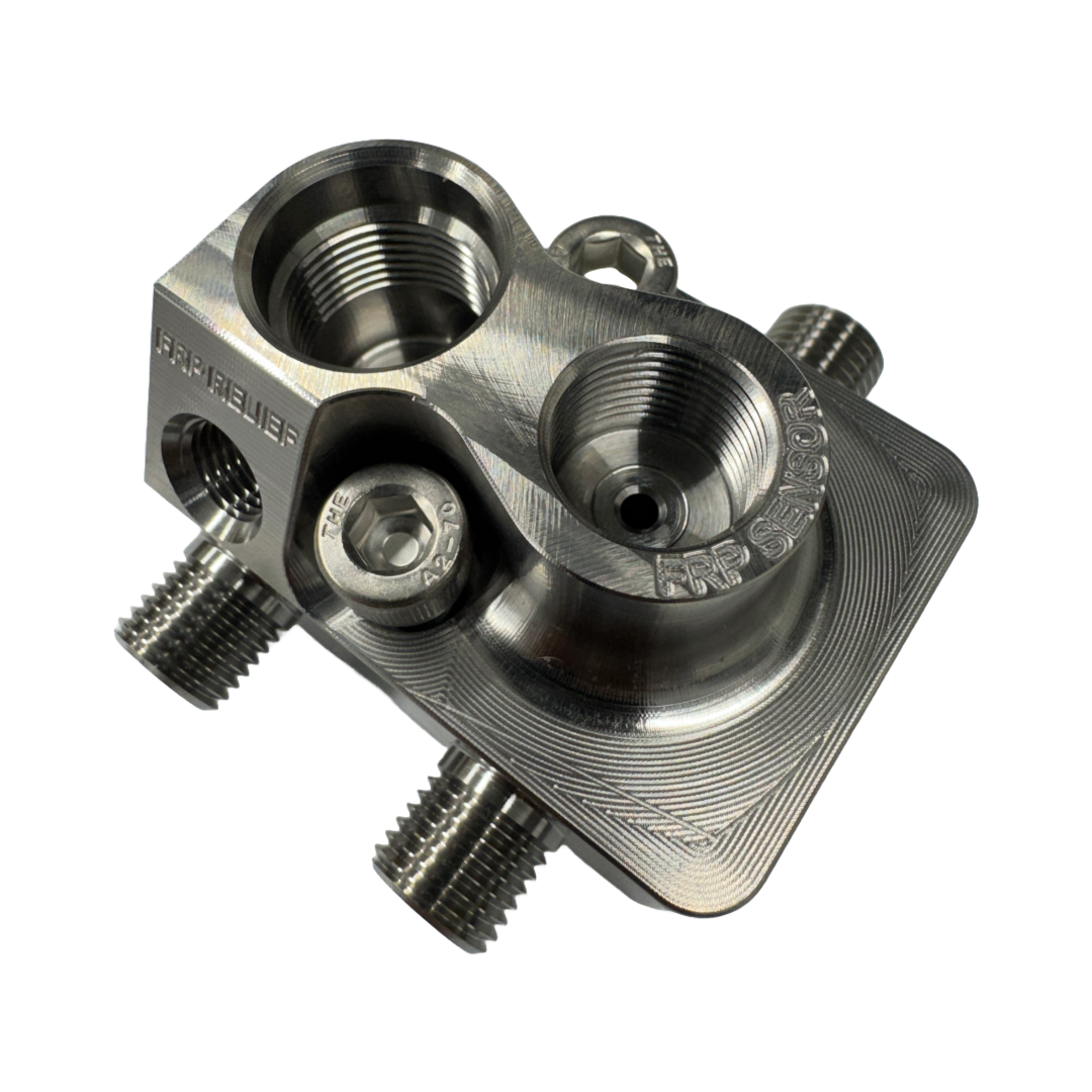 DP Customs LB7 Fuel Distribution Block showing metal construction and multiple connection ports for diesel engine fuel lines.