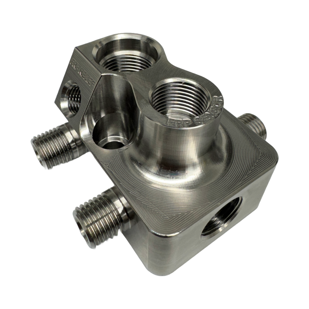 DP Customs LB7 fuel distribution block with multiple outlets for fuel line connections, shown in close-up view.