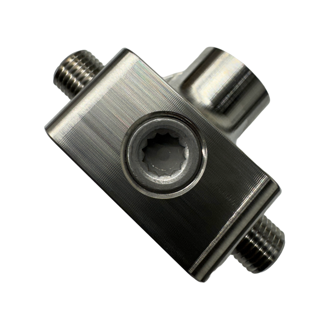 DP Customs LB7 fuel distribution block with multiple ports for engine fuel lines, black metal construction, visible mounting points.