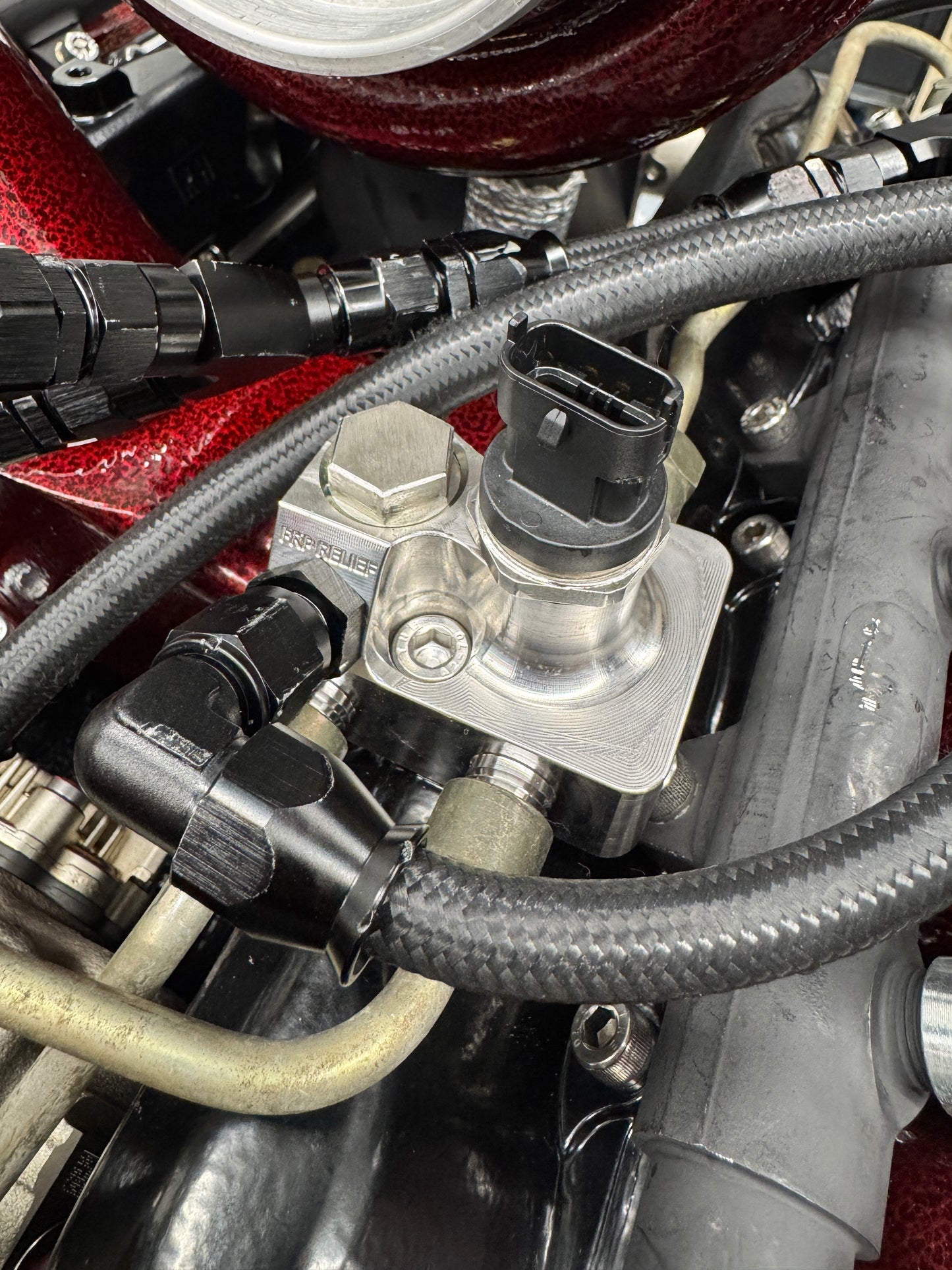 DP Customs LB7 fuel distribution block with multiple ports for efficient fuel line management and secure fitting.