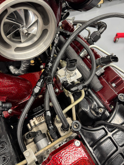 DP Customs LB7 fuel distribution block with multiple ports, mounted on a metal surface for vehicle fuel system customization.
