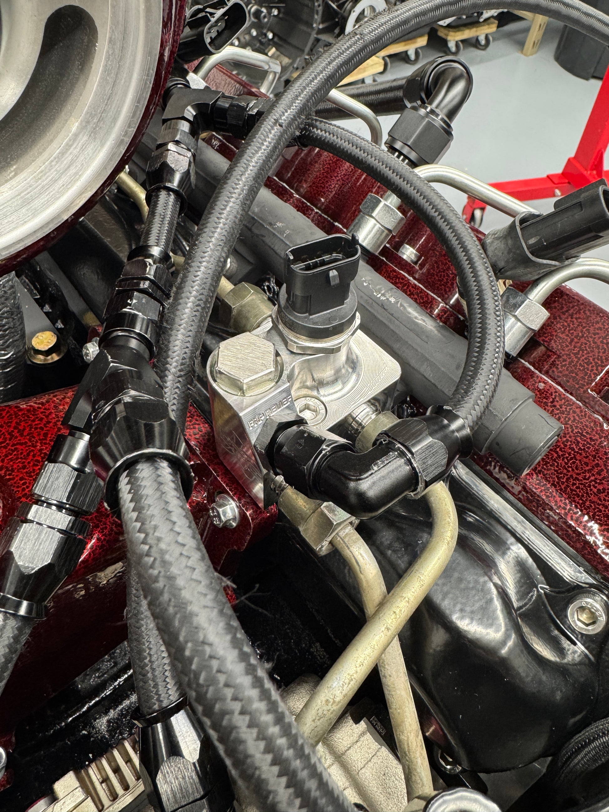 DP Customs LB7 Fuel Distribution Block showing multiple connection ports on a metal component