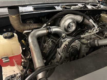 DP Customs DPC LBZ Duramax S400 single turbo kit installed on a Duramax engine, showcasing the turbocharger and piping system.