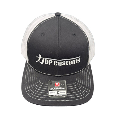 Black DPC Trucker Hat by DP Customs with mesh back and curved brim, featuring the brand logo on the front panel.