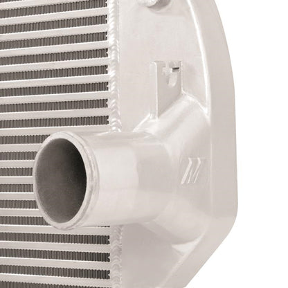 Mishimoto intercooler for 2001-2005 Duramax diesel truck, black aluminum core, with inlet and outlet hoses attached.