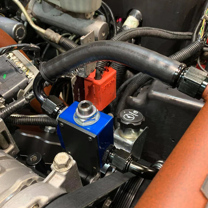 SoCal Diesel Water Pump Bypass kit showing metal components and hoses for vehicle water pump bypass system