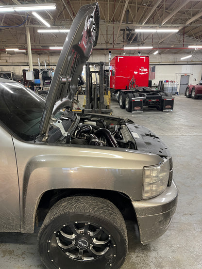 DP Customs High Access Hood Brackets installed on a 2007.5-2016 GM truck, showing sturdy metal brackets for easy hood access.