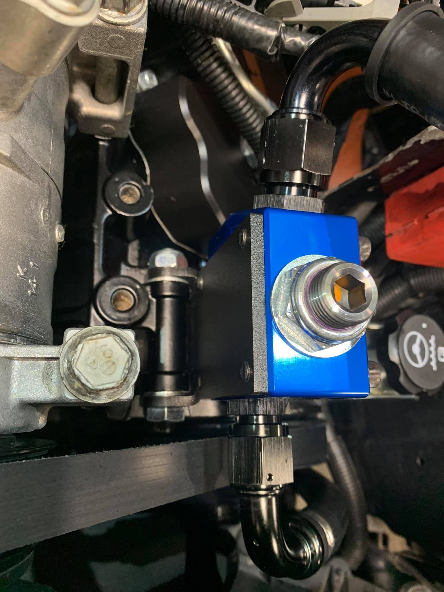 DP Customs SoCal Diesel waterpump bypass bracket installed on a vehicle engine, showcasing durable metal construction and precise fit.